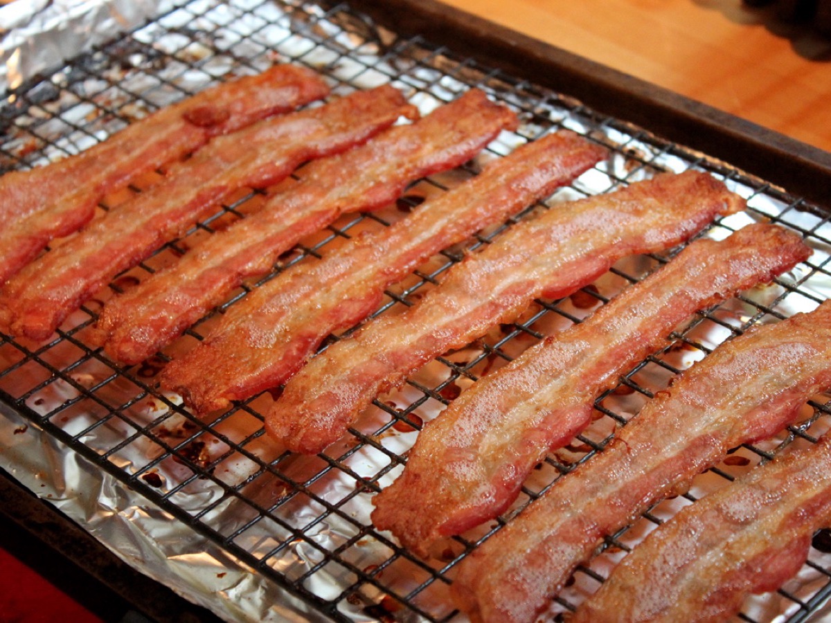 Strips of thick-cut bacon on a rack
